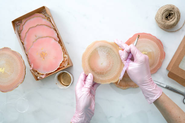 istock Creativity and craft. A young girl creates coasters from resin. Gift wrapping. Decorative packaging. Idea for business. Remote work, work at home. Art coasters. 1214149532