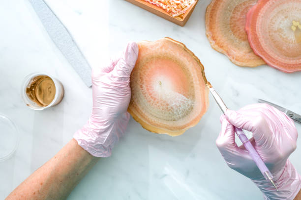 Creativity and craft. A young girl creates coasters from resin. Gift wrapping. Decorative packaging. Idea for business. Remote work, work at home. Art coasters.
