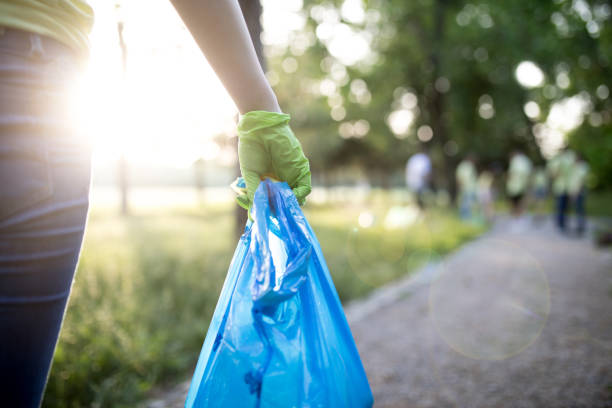 istock Young volunteer cleaning up environment 1214154275