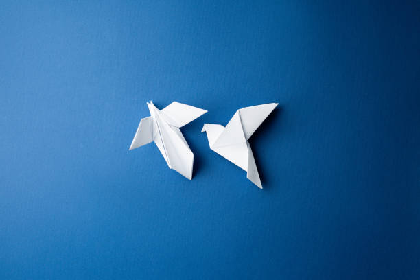 istock Paper pigeon on a blue isolated background. 1214155213