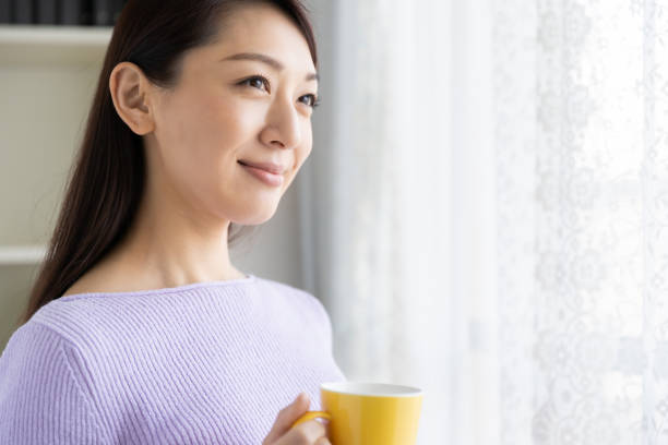 istock asian woman who drink coffee 1214157926