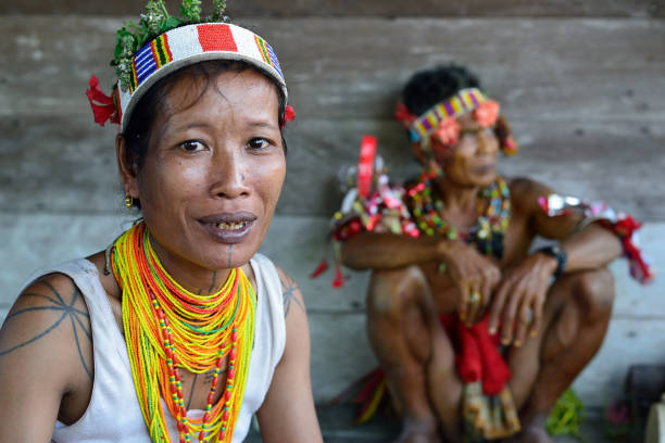 Muara Siberut, Mentawai Islands, Indonesia, 3 NOVEMBER 2019: Portrait  tribal woman - shaman, with traditional tattoos, at his rainforest home Uma, during the traditional ceremony for the protection of the clan
