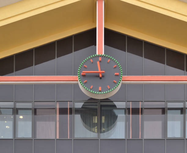 istock A round black clock on the front of a city building . 1214159563