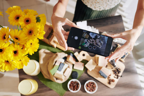 Woman photographing desk with fragrant soap