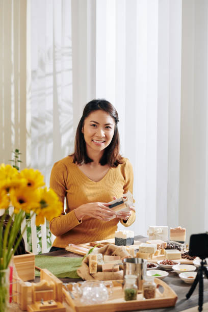istock Smiling woman packing soap 1214164847