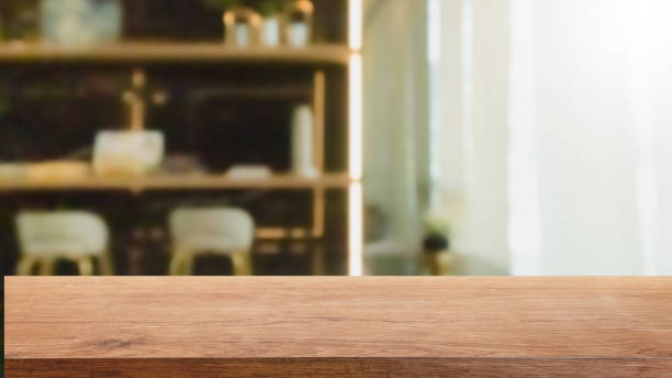 istock Empty wood table top and blurred home interior with window room background. - can used for display or montage your products. 1214164911