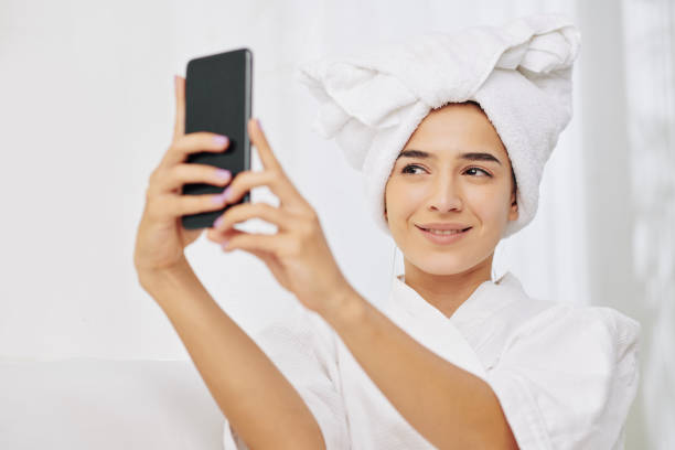 istock Woman phototgraphing in bath robe 1214165223
