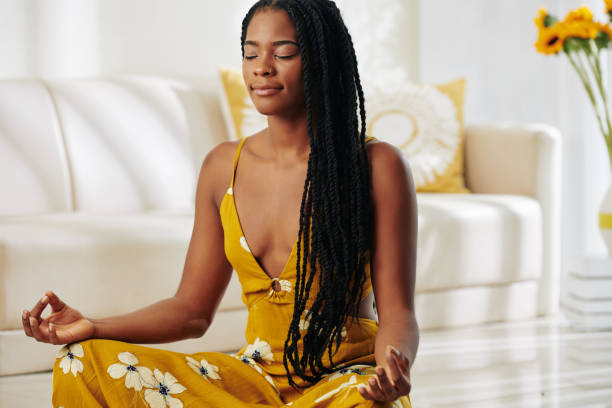 istock Pretty woman meditating at home 1214165947