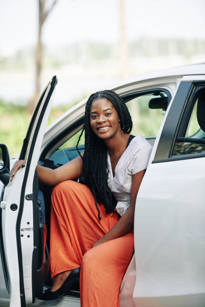 Smiling woman sitting in new car