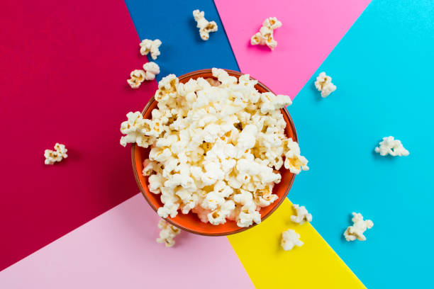 istock Plate with popcorn on a bright colored background. Top view. 1214172216