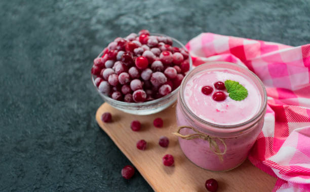 istock Frozen cranberry yogurt on a black background. 1214172410