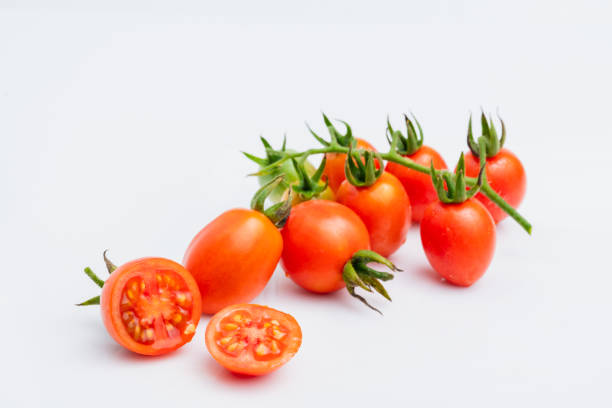 fresh red cherry tomatoes (grape tomatoes ) on white background. fresh red cherry tomatoes (grape tomatoes ) on white background. grape tomato stock pictures, royalty-free photos & images