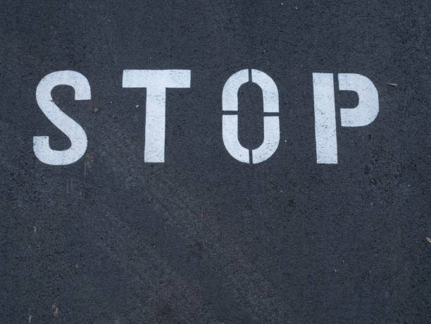 istock Stop sign painted on the asphalt 1214176765