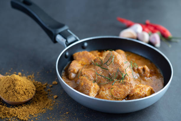istock Massaman curry in a frying pan with spices on the cement floor. Selective focus 1214177748
