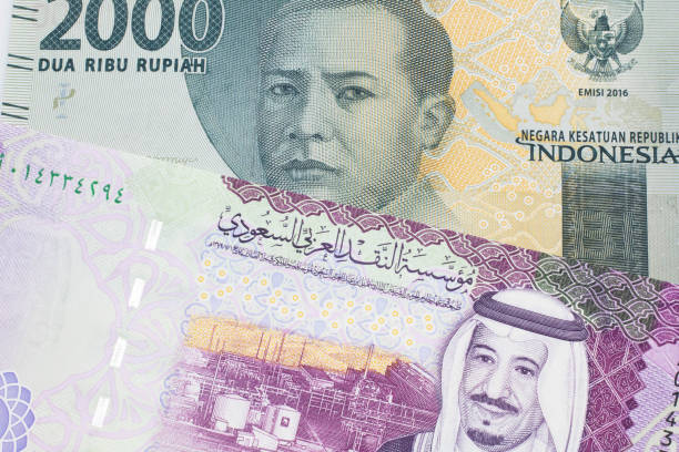 istock An Indonesian rupiah bank note with a Saudi Arabian five riyal bill 1214178374