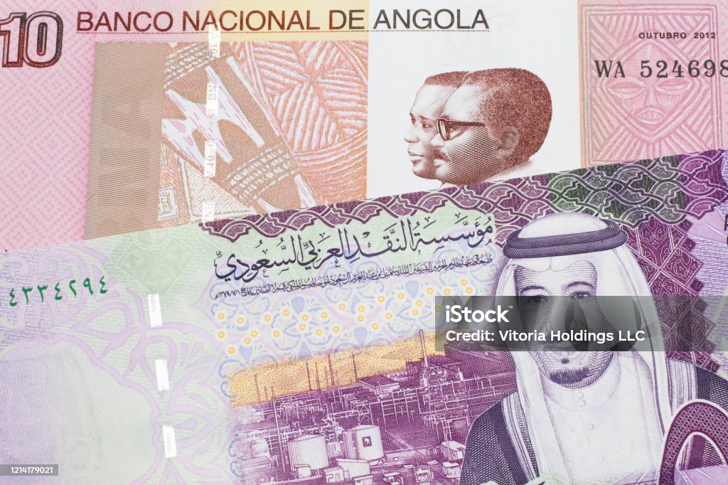 Colorful currency from Angola with Saudi Arabian money A colorful ten kwanza bill from Angola with a colorful, Saudi Arabian riyal bank note close up in macro Africa Stock Photo