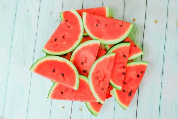 Photo of watermelon on blue wooden background