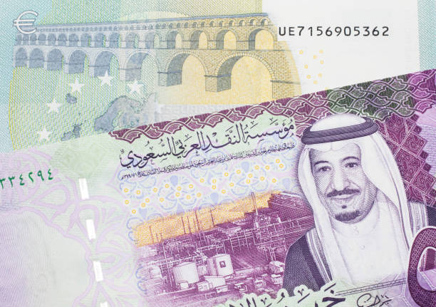 istock A Euro bank note with a colorful Saudi Arabian bank note 1214179174