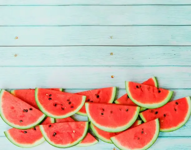 Photo of watermelon on blue wooden background