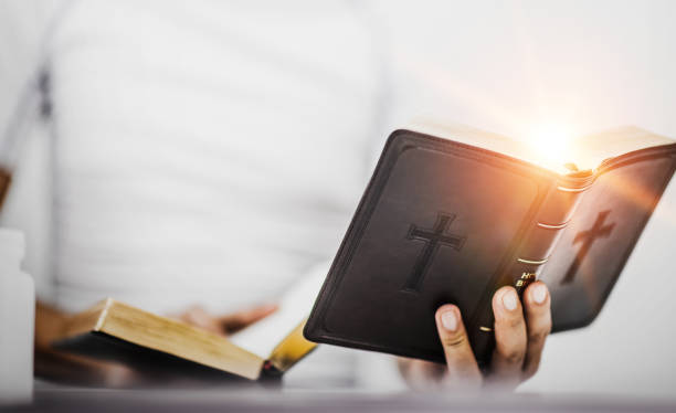 istock Young man with bible while reading, believe concept. 1214180675