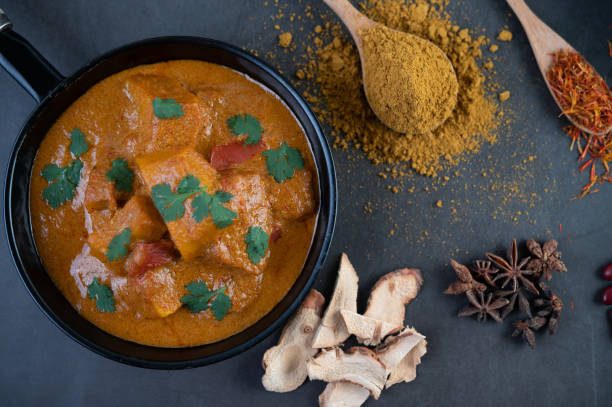 istock Massaman curry in a frying pan with spices on the cement floor. Selective focus 1214180690