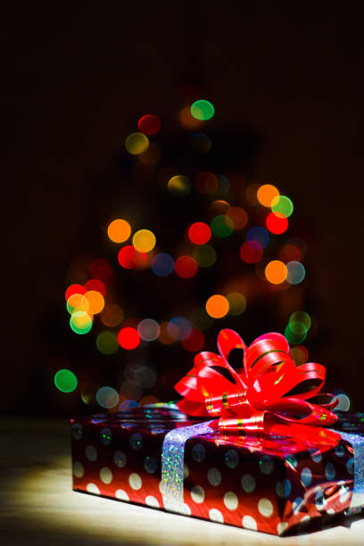 istock Gift box against the background of multicolored lights 1214182970