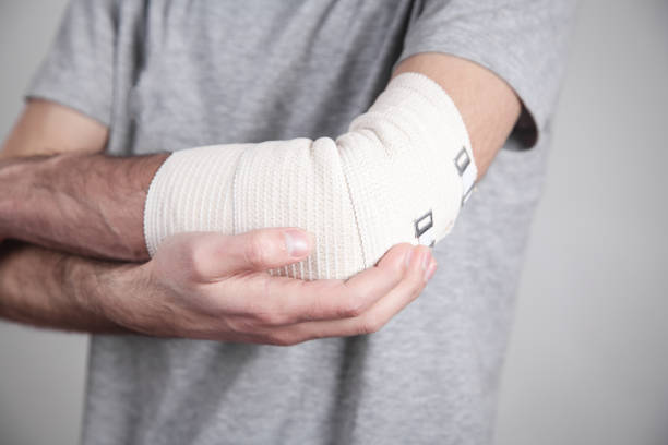 istock Man hand with elastic bandage on elbow. 1214185718
