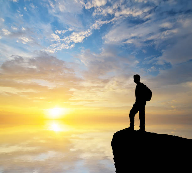 istock Man tourist looking on the sunset. 1214186671
