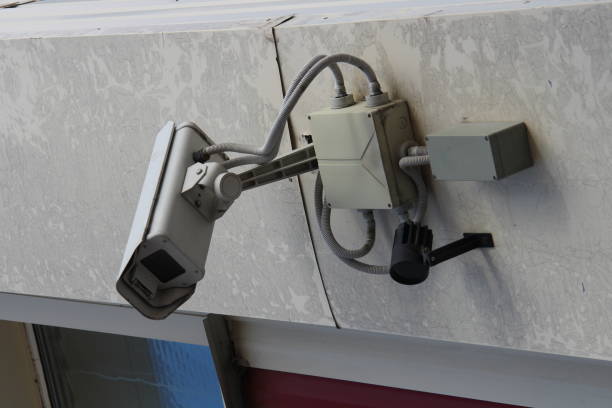 istock Surveillance camera mounted on wall of house 1214188738