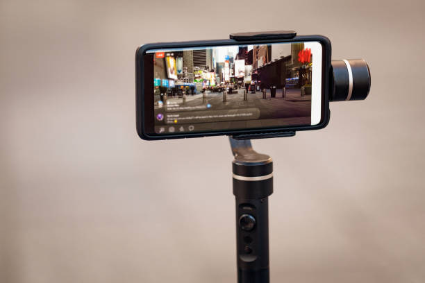 istock Phone with stabilizer, tripod, gimbal taking photo or video 1214189101