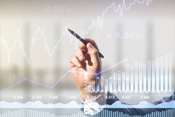 istock Multi exposure of analyst hand with pen working with virtual abstract financial diagram on blurred office background, banking and accounting concept 1214189658