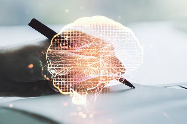 istock Creative artificial Intelligence concept with human brain sketch and man hand writing in diary on background. Double exposure 1214189918