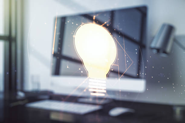 istock Double exposure of creative light bulb hologram on laptop background, research and development concept 1214190899