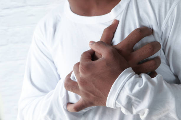 istock young man suffering heart pain, close up 1214192007