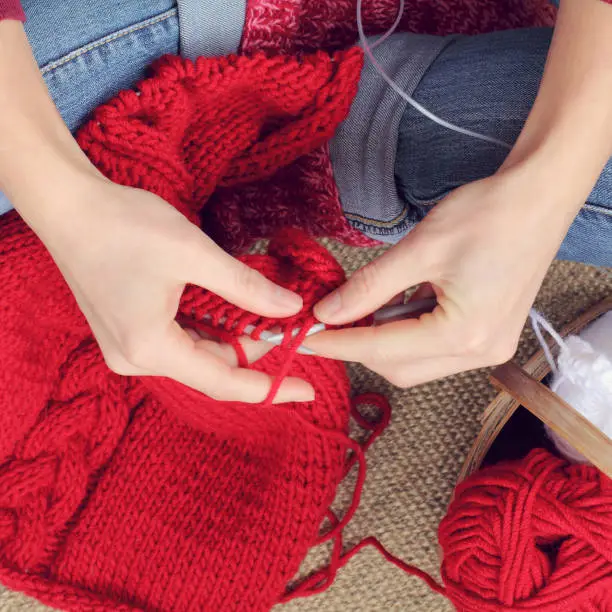 knitting with needles of a warm sweater