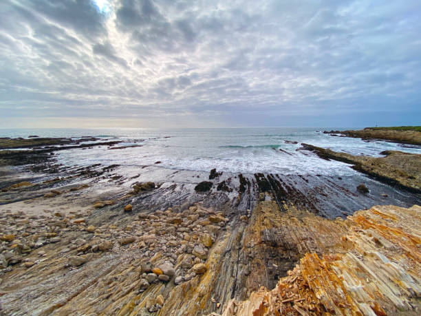 istock Dynamic picture of low tide seashore , rocks and surreal looking clouds  (California seascape) 1214196426