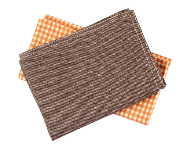 istock crumpled orange brown checkered napkin table clothes  on white background. 1214198608