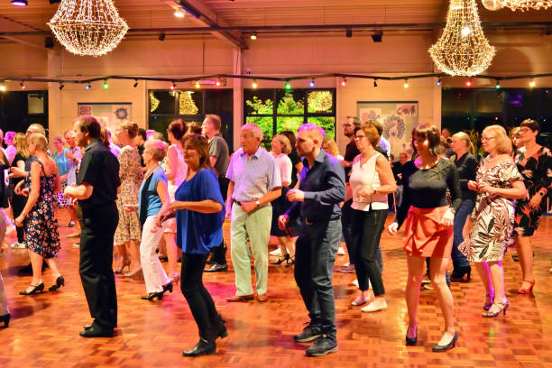 Workshop classes. Indoor line dancing by a professional instructor. Herent, Belgium - September 14, 2019: Open House indoor dancing classes evening show. Photo reportage open door promotion indoor dance classes. Courses starting half September. Teacher in front of group demonstrates solo dance. teacher retirement party stock pictures, royalty-free photos & images
