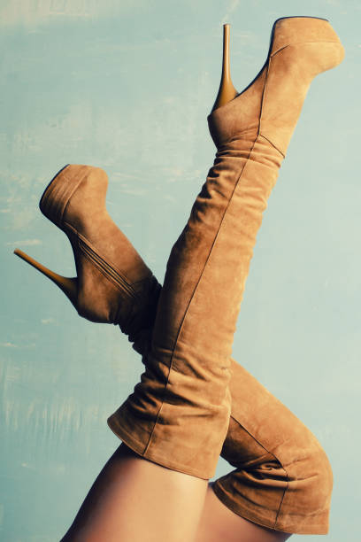 istock female legs in beige suede high-heeled boots 1214199516