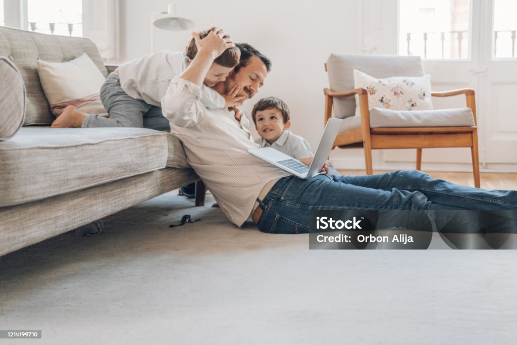 Father trying to work from home Family Stock Photo
