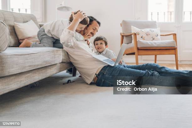 Father Trying To Work From Home Stock Photo - Download Image Now - Family, Domestic Life, Home Interior