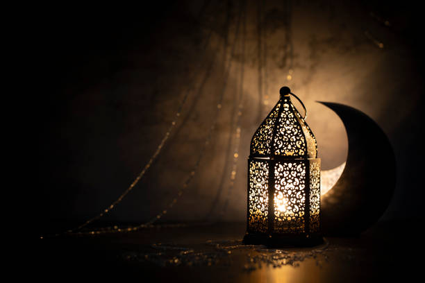 istock Dark photography of a crescent moon and a lantern with a dim lighting effect. 1214199996