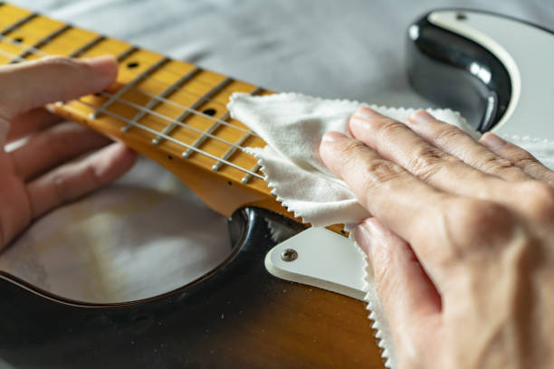istock Cleaning electric guitar with microfiber cloth 1214200169