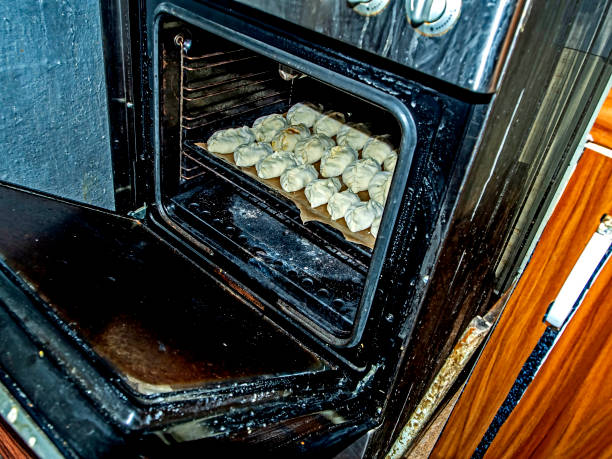 istock placing raw pies in the baking oven 1214201370