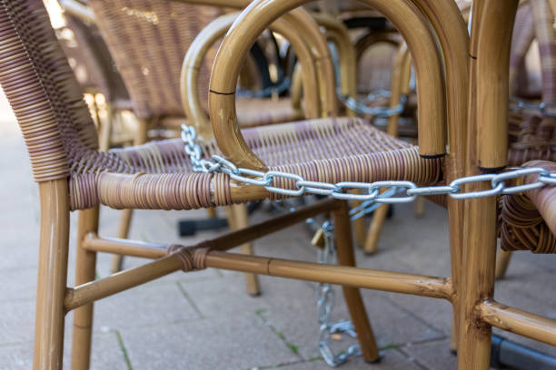 locked chairs in a city as a result of the corona virus locked chairs in a city as a result of the corona virus or covid-19 camel colored photos stock pictures, royalty-free photos & images