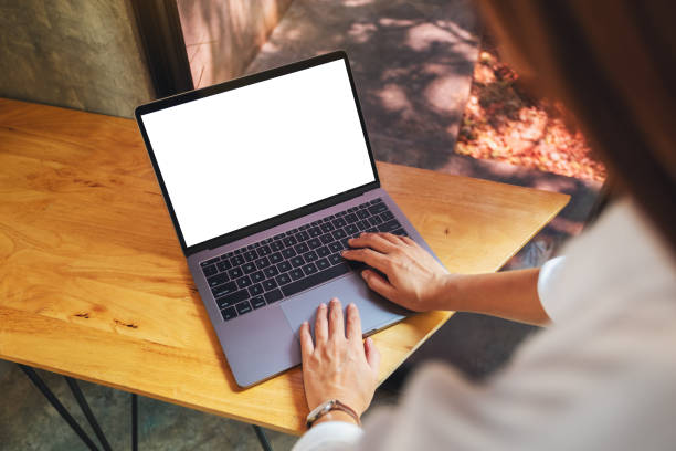 istock a woman using and typing on laptop computer with blank white desktop screen on wooden table 1214203500