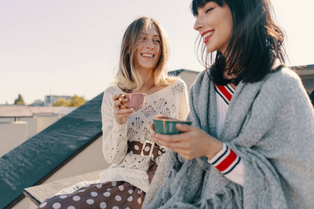 istock Two attractive girls enjoy a tea party 1214203986