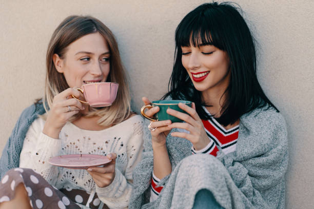 istock Two attractive girls enjoy a tea party 1214205267