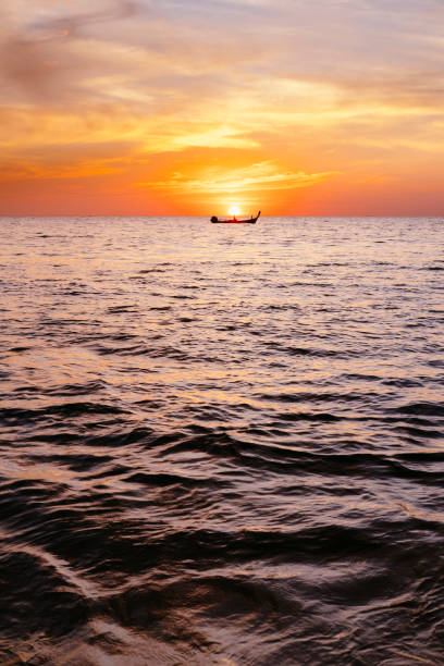 istock Serene seascape sunrise with a boat with copy space 1214206687