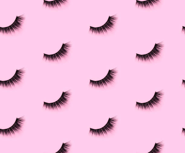 Pattern with eyelashes on pink background Pattern with eyelashes on pink background. Flat lay top view minimal template feminine greeting card. false lashes stock pictures, royalty-free photos & images